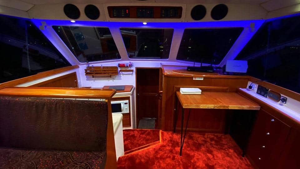 Elegant yacht interior featuring navigation controls and comfortable seating for a premium cruising.