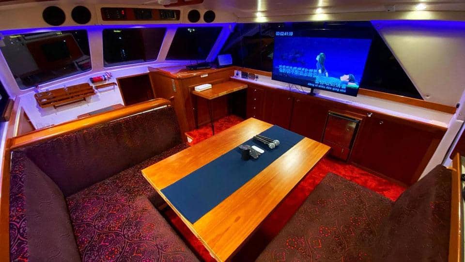 Elegant yacht lounge with comfortable seating and a large flat-screen TV.